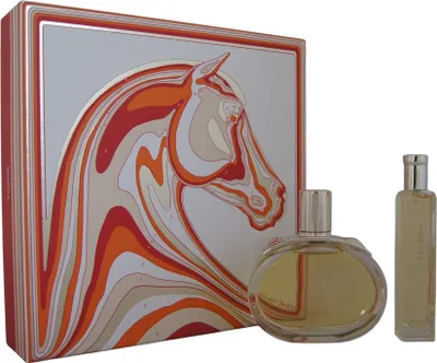 A perfume set with a decorative box and two bottles of perfume.