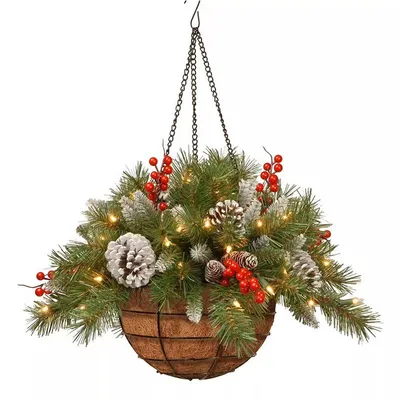 A hanging Christmas decoration basket filled with artificial pine branches, pinecones, and red berries, illuminated by small LED lights.