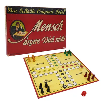A vintage board game box and board with playing pieces and a die.
