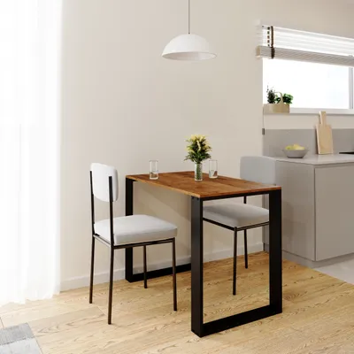 A small dining table with two chairs in a modern kitchen setting.