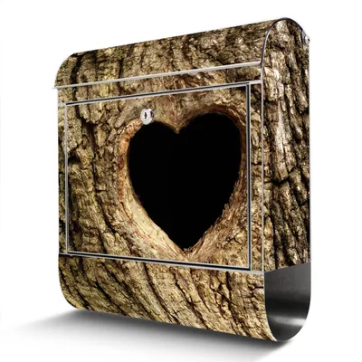 A mailbox designed to look like a tree trunk with a heart-shaped opening.