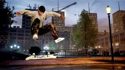 A skateboarder performing a trick in a city at dusk.
