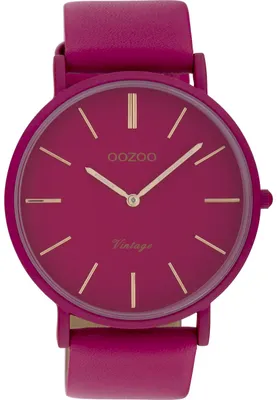 A close-up studio shot of a fuchsia colored wristwatch.