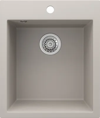 A top-down view of a beige sink with a silver drain.