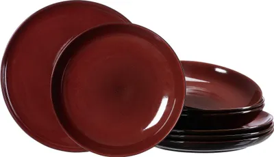 A set of red and brown plates stacked and arranged on a white background.