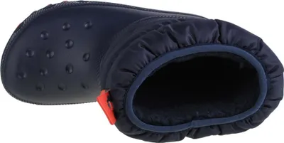 A top-down view of a navy blue Crocs boot with a red accent.
