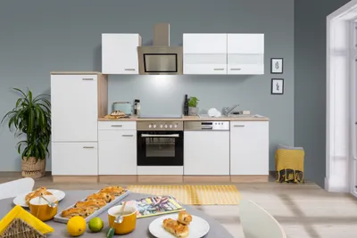 A modern kitchen setup with white cabinets and wood accents.
