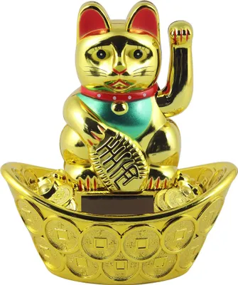 A golden lucky cat figurine sitting in a boat filled with coins.