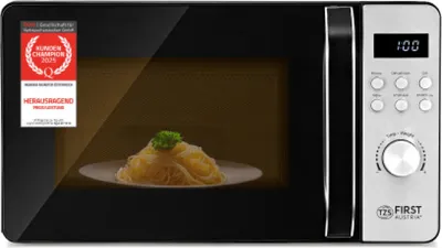 A microwave oven with a plate of spaghetti inside. There is a promotional badge on the left side of the microwave door.
