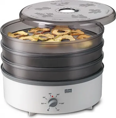 A Stöckli food dehydrator filled with dried apple slices.