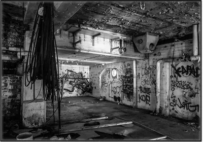 Produktbild von Wallario Wandbild Alte verlassene Fabrik in schwarz weiß mit Graffiti, Größe: 70,30 x 100,30 cm, Poster mit schwarzem Aluminiumrahmen