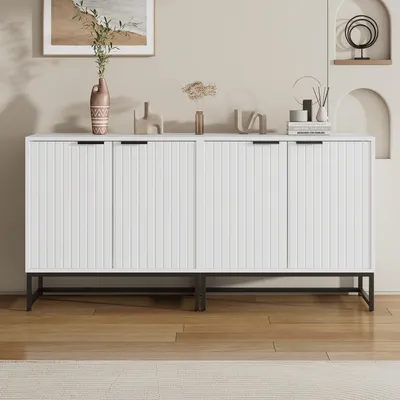 A white sideboard with fluted doors and black legs.