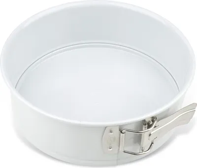 A white springform baking pan with a silver latch is shown against a white background.