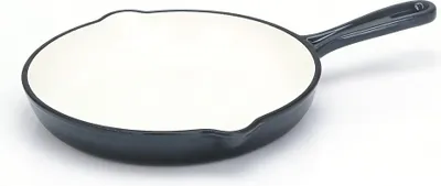 A cast iron frying pan with a white interior and black exterior is shown on a white background.