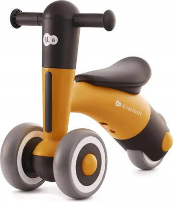A studio shot of a yellow and black balance bike for toddlers.