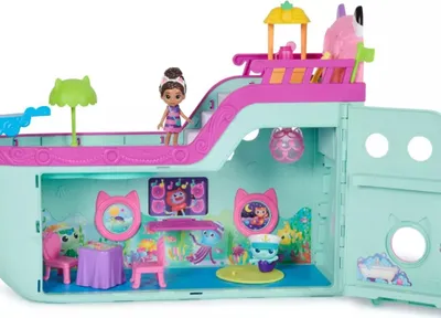 A toy cruise ship playset with a doll and accessories.