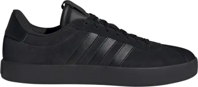 A studio shot of a single black Adidas sneaker.