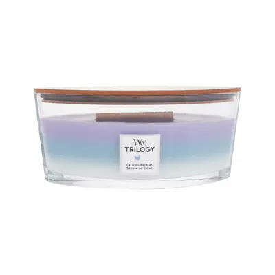 A candle in a glass container with a wooden lid.
