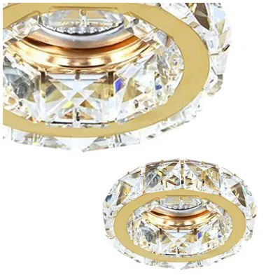 A close-up view of a crystal and gold light fixture.