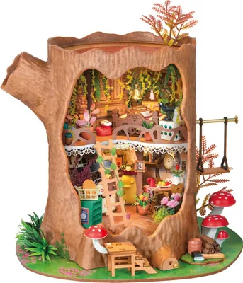 A miniature, intricately detailed treehouse model inside a hollowed-out tree trunk, complete with furniture, plants, and accessories.
