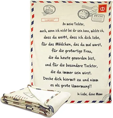 A blanket designed to look like an envelope with a letter inside, with a folded blanket in the foreground.