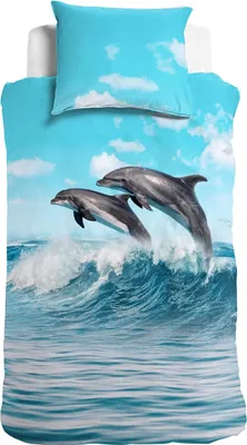 A duvet cover and pillowcase set featuring a vibrant image of dolphins jumping out of the ocean waves under a blue sky with clouds.