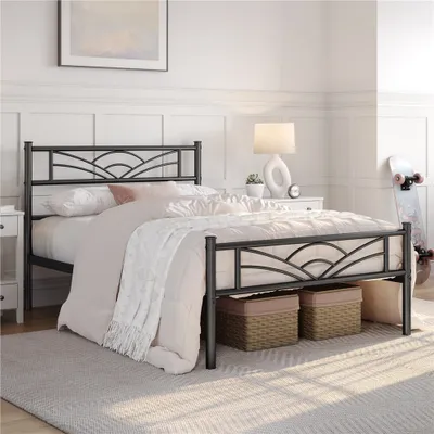 A black metal bed frame with a cloud pattern headboard is shown in a bedroom setting.