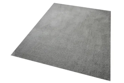A gray shaggy rug is shown from a diagonal angle on a white background.