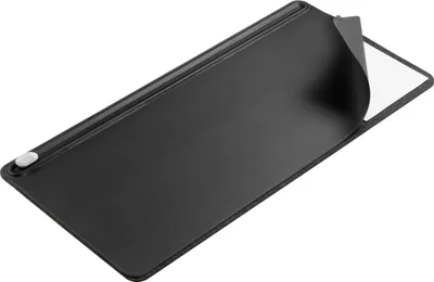 A black desk mat with a corner peeling back to reveal a white backing.