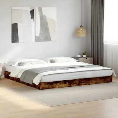 A bed frame with bedding in a bedroom setting.