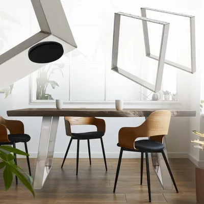 A dining table with metal legs and wooden chairs in a well-lit room.