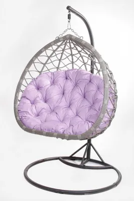 A hanging egg chair with a purple cushion, isolated on a white background.