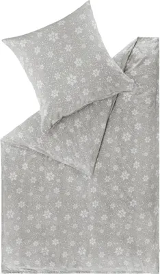 A folded duvet cover and pillowcase with a snowflake pattern.