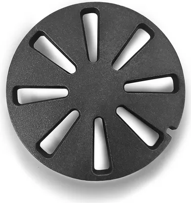 A black circular grate with triangular cutouts, shown from a top-down perspective against a white background.
