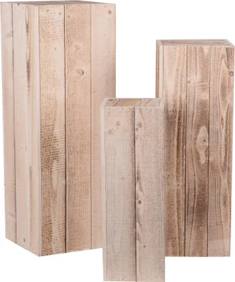 Three wooden pedestals of varying heights are arranged together against a white background.