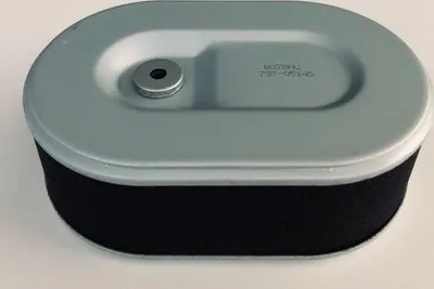 A close-up studio shot of an oval-shaped air filter with a gray metal top and a black foam filter element.