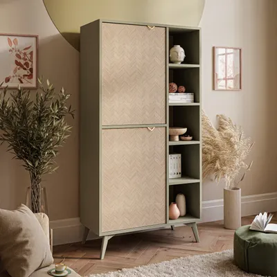A tall, narrow cabinet with two doors and open shelves, decorated with houseplants and decorative objects in a living room setting.