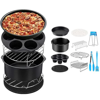 A collection of air fryer accessories, including baking pans, racks, and utensils, with a pizza in one of the pans.