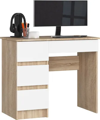 A computer desk with drawers and a monitor on top.