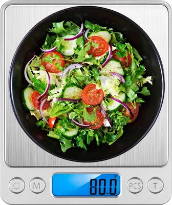 A digital scale with a bowl of salad on top.