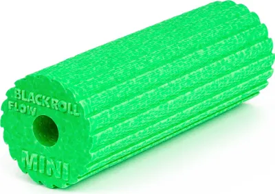 A green foam roller with textured surface and text on the end.