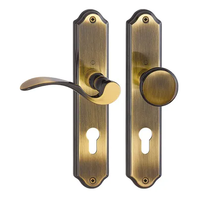 A pair of antique brass door handles with escutcheons, displayed against a white background.