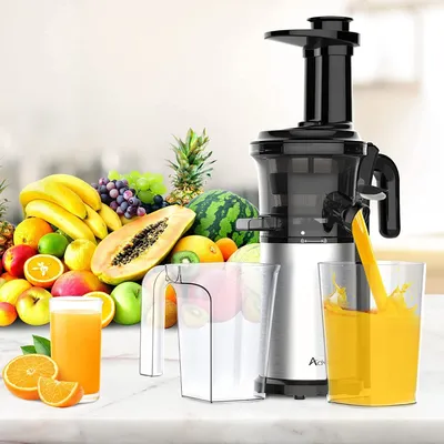 A juicer is shown with a variety of fresh fruits and a glass of juice, suggesting a healthy lifestyle.