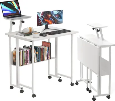 A white folding desk with a laptop, monitor, and keyboard on it, and a shelf with books underneath. Another desk is shown folded on the right.