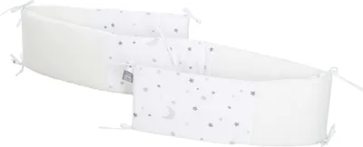 A baby crib bumper with a star and moon pattern.