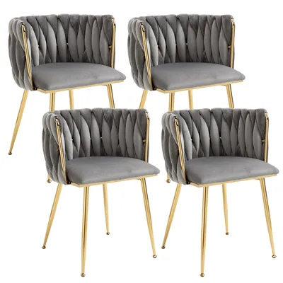 Four gray velvet dining chairs with gold metal frames are arranged in a two-by-two grid against a white background.