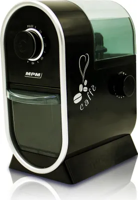 A black coffee grinder with silver trim and a transparent green lid.
