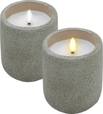 Two LED candles in concrete-look pots are shown against a white background.