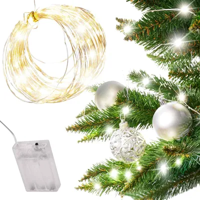 A close-up of a Christmas tree with lights and ornaments, and a separate battery pack for the lights.
