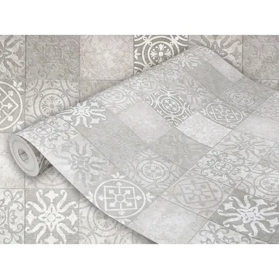 A roll of wallpaper with a tile-like pattern is partially unrolled, showing the design up close.